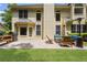View of the back of the home with a brick patio, outdoor furniture, and barbeque grill at 350 Medridge Dr, Johns Creek, GA 30022