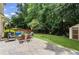 Backyard with an outdoor seating area on a stone patio and a shed on the lawn at 350 Medridge Dr, Johns Creek, GA 30022