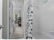 Bathroom features a tub with a shower curtain and view to hallway at 350 Medridge Dr, Johns Creek, GA 30022