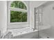 Bathroom features a large soaking tub with a window offering natural light at 350 Medridge Dr, Johns Creek, GA 30022