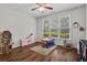 Bright bedroom featuring a ceiling fan, hardwood floors, and large windows for natural light at 350 Medridge Dr, Johns Creek, GA 30022