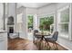 Bright breakfast nook with hardwood floors, large windows, and views of the outdoor patio and backyard at 350 Medridge Dr, Johns Creek, GA 30022