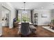 Dining area with a farmhouse table, bench seating, an industrial-style chandelier, and natural light from a large window at 350 Medridge Dr, Johns Creek, GA 30022