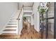 Inviting entryway with hardwood floors, staircase, and view into the living area at 350 Medridge Dr, Johns Creek, GA 30022