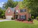 Charming two-story brick home with a well-manicured lawn and attached two-car garage at 350 Medridge Dr, Johns Creek, GA 30022