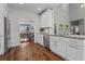Bright kitchen with white cabinets, granite counters, stainless appliances, and view into the dining area, perfect for entertaining at 350 Medridge Dr, Johns Creek, GA 30022