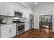 Kitchen features stainless steel appliances, white cabinets, and granite countertops, with an adjacent dining area at 350 Medridge Dr, Johns Creek, GA 30022