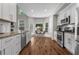 Bright, spacious kitchen with white cabinets, granite countertops, stainless steel appliances, and a view of the backyard at 350 Medridge Dr, Johns Creek, GA 30022