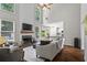 Spacious living room with tall ceilings, fireplace, large windows, and open layout to the kitchen at 350 Medridge Dr, Johns Creek, GA 30022