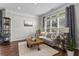 Cozy living room with large windows, a comfortable couch, and hardwood floors at 350 Medridge Dr, Johns Creek, GA 30022