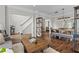 Bright living room with hardwood floors, neutral paint, and an open floor plan leading to the dining area and staircase at 350 Medridge Dr, Johns Creek, GA 30022
