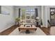 Cozy living room with large windows, a comfortable couch, and hardwood floors at 350 Medridge Dr, Johns Creek, GA 30022