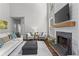Bright living room featuring a fireplace, mounted television, and plush seating for relaxing and entertaining at 350 Medridge Dr, Johns Creek, GA 30022