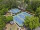 Aerial view of community tennis courts, playground, and picnic area, surrounded by lush green trees at 350 Medridge Dr, Johns Creek, GA 30022