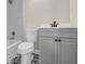 Cozy bathroom with gray vanity, modern fixtures, and decorative tile floor at 3571 Kennesaw Station Nw Dr, Kennesaw, GA 30144