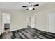 Bright bedroom features gray wood flooring, neutral walls, white trim, and an open door to the Primary bath at 3571 Kennesaw Station Nw Dr, Kennesaw, GA 30144