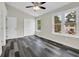 Bright bedroom featuring hardwood floors, vaulted ceilings, and large windows for ample natural light at 3571 Kennesaw Station Nw Dr, Kennesaw, GA 30144