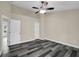 Bright bedroom features gray wood flooring, neutral walls, white trim, and a ceiling fan at 3571 Kennesaw Station Nw Dr, Kennesaw, GA 30144
