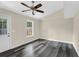 Comfortable bedroom featuring a ceiling fan, natural light, and wood-look flooring at 3571 Kennesaw Station Nw Dr, Kennesaw, GA 30144