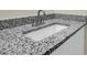 Close up of a granite bathroom countertop with a white sink and brushed nickel faucet at 3571 Kennesaw Station Nw Dr, Kennesaw, GA 30144