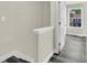 Light-filled hallway features gray wood flooring, neutral walls, and white trim at 3571 Kennesaw Station Nw Dr, Kennesaw, GA 30144