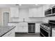 Bright, updated kitchen with white cabinets, stainless steel appliances, and granite countertops at 3571 Kennesaw Station Nw Dr, Kennesaw, GA 30144
