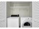 Convenient laundry area featuring washer and dryer hookups with shelving for storage at 3571 Kennesaw Station Nw Dr, Kennesaw, GA 30144