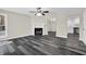 Inviting living room with a cozy fireplace, ceiling fan, and wood-look flooring at 3571 Kennesaw Station Nw Dr, Kennesaw, GA 30144