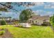 Sprawling backyard with a sparkling pool, lush lawn, and inviting patio offers ample space for outdoor enjoyment at 525 E Main St, Buford, GA 30518