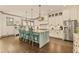Bright open kitchen with stainless appliances, island with seating, and hardwood floors at 525 E Main St, Buford, GA 30518