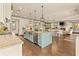 Bright, open kitchen with island and stainless steel appliances flows into living areas at 525 E Main St, Buford, GA 30518