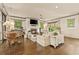 Open living room boasts hardwood floors, fireplace, shiplap walls, and an abundance of natural light at 525 E Main St, Buford, GA 30518