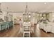 Open concept living space with dining table, kitchen island, hardwood floors and oversized windows at 525 E Main St, Buford, GA 30518