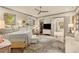 Spacious main bedroom with a king-size bed, sitting area, hardwood floors, and stylish decor at 525 E Main St, Buford, GA 30518