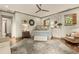 Inviting main bedroom showcasing hardwood floors, a king-size bed, and an adjacent seating area with natural lighting at 525 E Main St, Buford, GA 30518