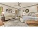 Relaxing main bedroom featuring a king-size bed, seating area, wood floors, and stylish decor at 525 E Main St, Buford, GA 30518