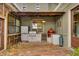 Outdoor kitchen with brick pavers, grill, and bar seating at 525 E Main St, Buford, GA 30518