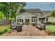 Expansive brick patio with stylish seating, outdoor dining, and serene landscaping offers a perfect outdoor retreat at 525 E Main St, Buford, GA 30518