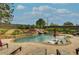 Inviting pool with tanning deck, waterfall feature, and meticulously maintained landscaping offers a private oasis at 525 E Main St, Buford, GA 30518
