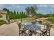 Lush backyard features a luxurious pool with a waterfall, lounge chairs, and manicured landscaping at 525 E Main St, Buford, GA 30518
