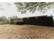 The exterior shows a fenced-in backyard with a deck and mature trees at 6914 N Baggett Rd, Douglasville, GA 30134