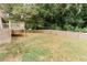 Spacious backyard featuring a wooden deck, lawn, and wooden fence at 6914 N Baggett Rd, Douglasville, GA 30134