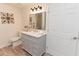 Bright bathroom with updated vanity, decorative mirror and modern lighting at 6914 N Baggett Rd, Douglasville, GA 30134