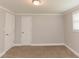 The bedroom has neutral walls, plush carpet, natural light and a closet at 6914 N Baggett Rd, Douglasville, GA 30134