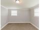 This bedroom features soft carpet, neutral walls, and natural light from two windows at 6914 N Baggett Rd, Douglasville, GA 30134