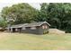 Charming, one-story brick home with black exterior paint, wooden shutters, and a lush front lawn at 6914 N Baggett Rd, Douglasville, GA 30134