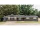 Single-story, brick home featuring a well-maintained lawn, brick chimney and a paved driveway at 6914 N Baggett Rd, Douglasville, GA 30134