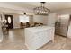 Open-concept kitchen seamlessly flows into the living room, featuring an island with quartz countertop at 6914 N Baggett Rd, Douglasville, GA 30134