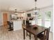 Spacious open kitchen and dining area with stainless steel appliances, new floors and eat-in kitchen island at 6914 N Baggett Rd, Douglasville, GA 30134