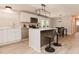 Modern kitchen boasts white cabinets, stainless steel appliances, and a stylish island with bar seating at 6914 N Baggett Rd, Douglasville, GA 30134